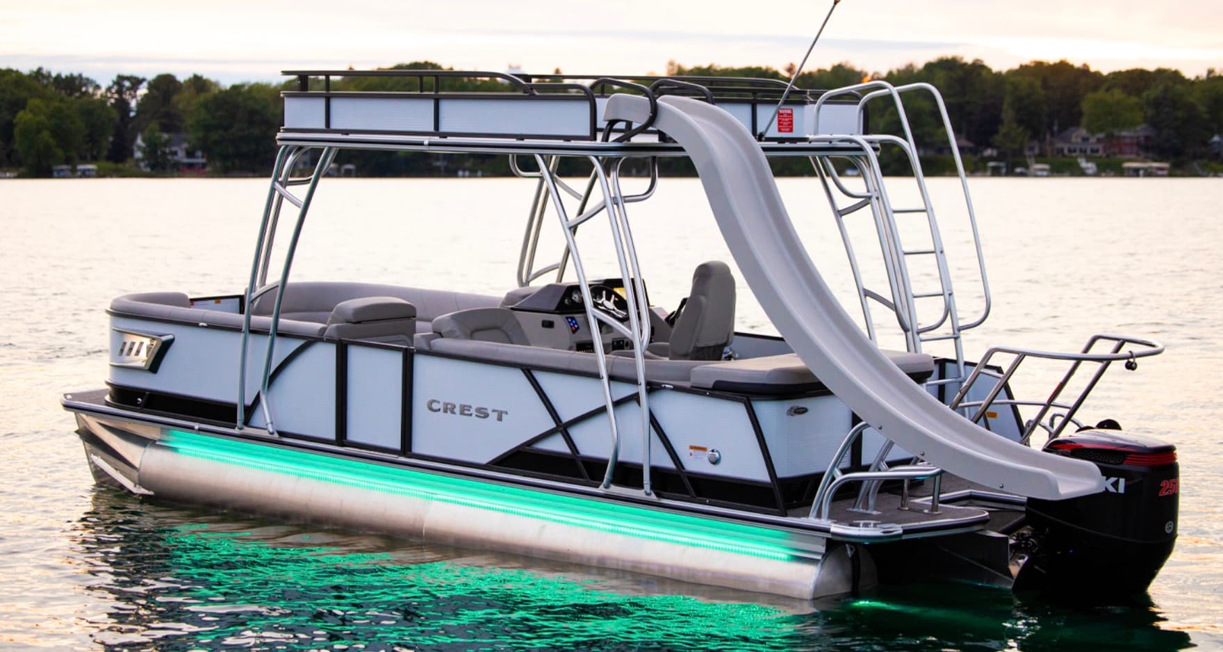 White double-deck pontoon boat with a water slide and upper sun deck