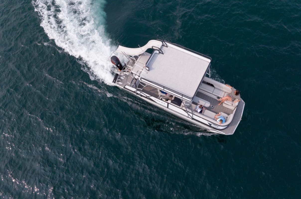 Aerial view of a double-deck slide pontoon boat under way