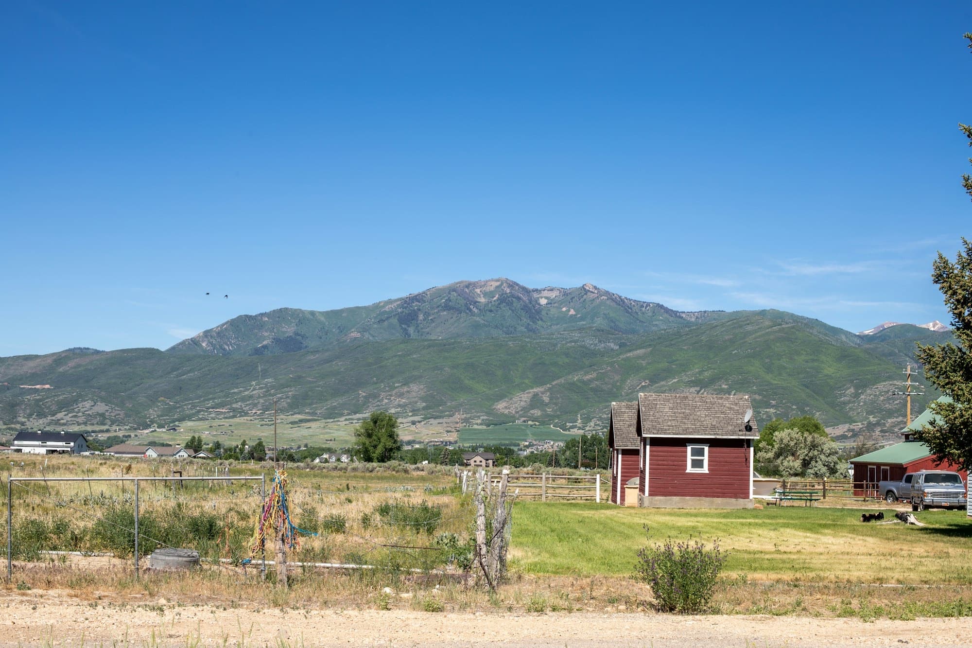 A farm in the green Heber Valley below the Wasatch mountains in summer