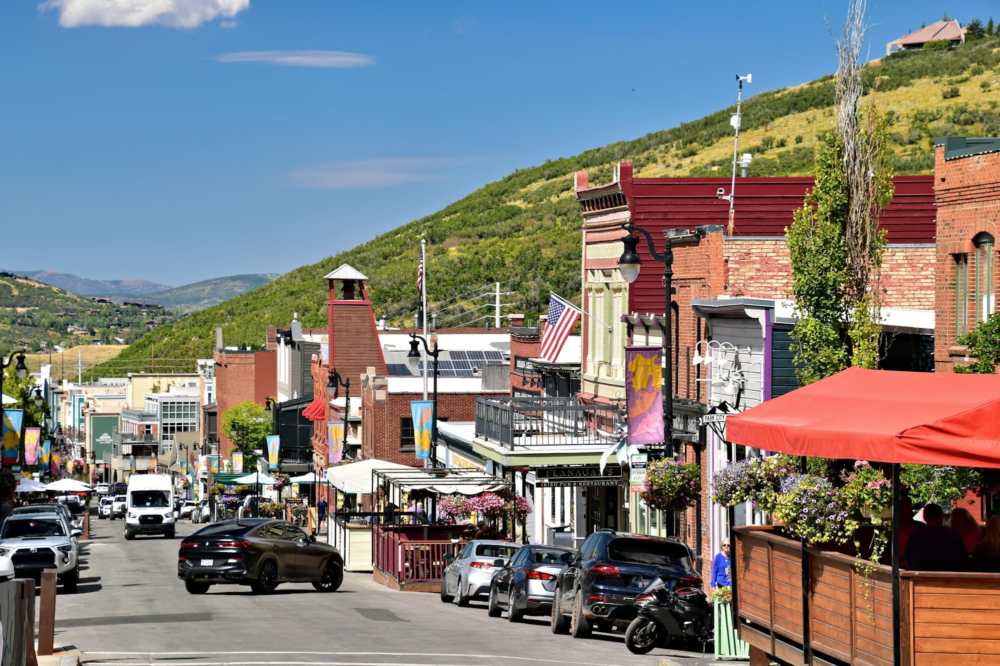 Park City's historic Main Street in summer with the green Wasatch hills behind