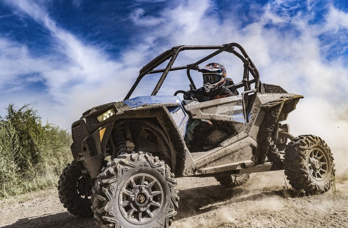 An ATV adventure buggy powering across rugged backcountry trail terrain on a Lofty Peaks tour